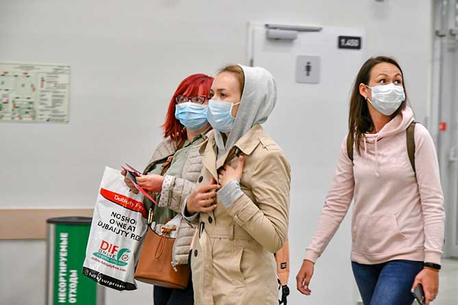 девушки в медицинских масках в аэропорту