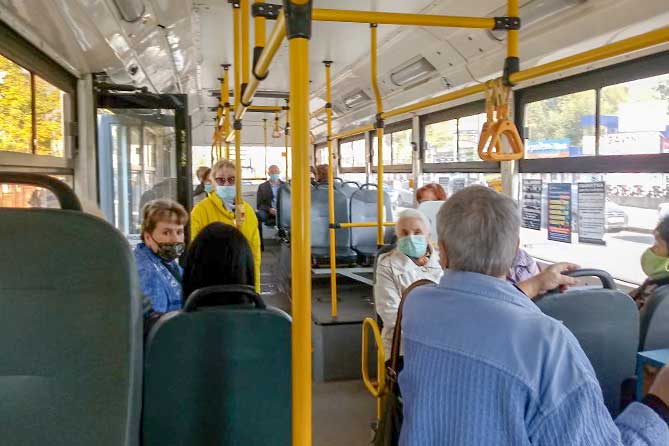 пассажиры в защитных маскаха в автобусе