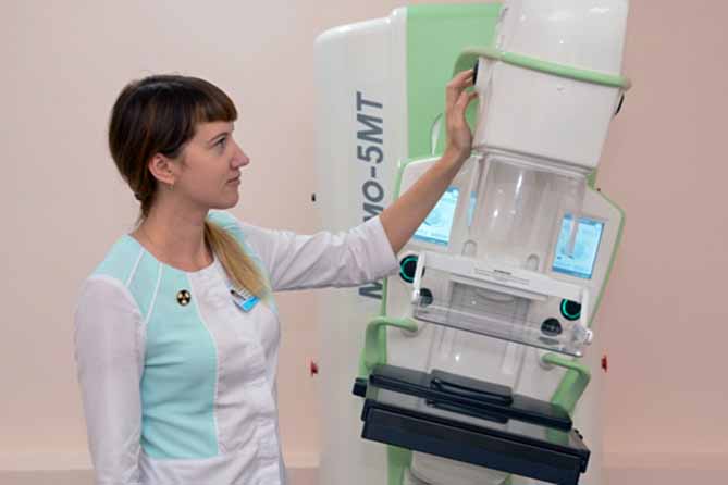 медсестра показывает аппарат маммография