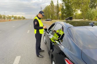сотрудник ГАИ проверяет документы водителя